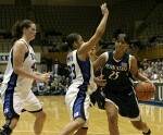 Penn State's Kamela Gissendanner drives against Wanisha Smith, as Alison Bales looks on