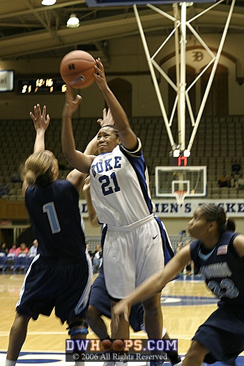 Joy Cheek twists around ODU's Tamara Ransburg on her way to the basket...