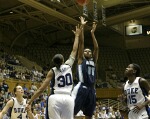 Shahida Williams shoots over Carrem Gay