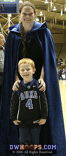 "Crazy Cape Girl" Sarah Bales (younger sister of Alison) poses with a young fan